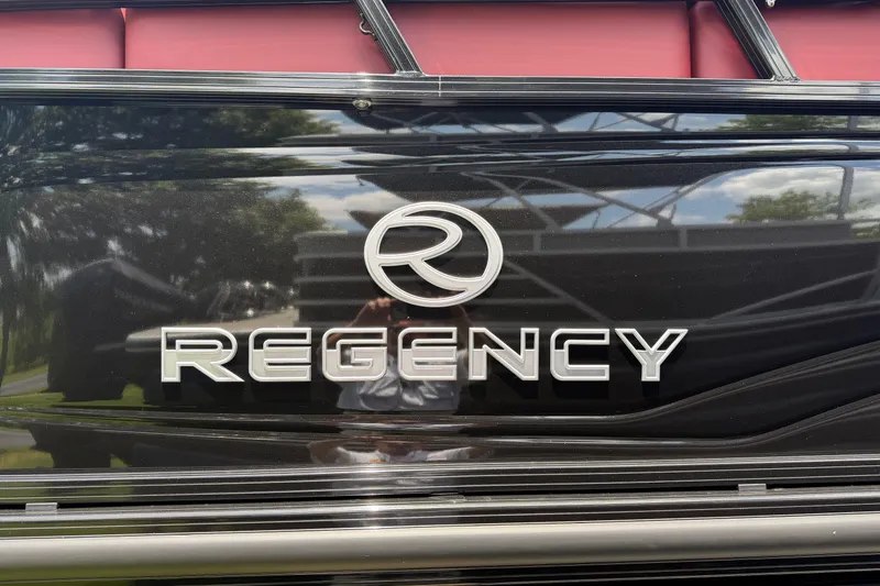 Slide: The Image of 2026 Regency 230 DL boat logo on sleek black surface. - 15