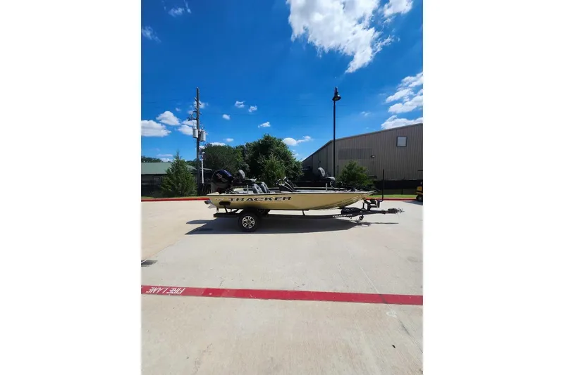 The Image of 2026 Tracker Pro Team 195 boat on trailer under clear blue sky. - 0