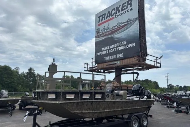 The Image of 2026 Tracker Grizzly 2072 CC Sportsman Kicker boat on trailer under cloudy sky. - 0