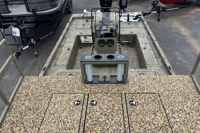 Slide: The Image of 2026 Tracker Grizzly 2072 CC Sportsman Kicker boat interior with fishing rod holders. - 11