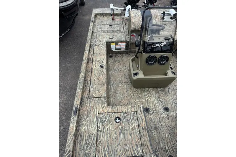 Slide: The Image of 2026 Tracker Grizzly 2072 CC Sportsman Kicker boat interior with camo design and control console. - 14