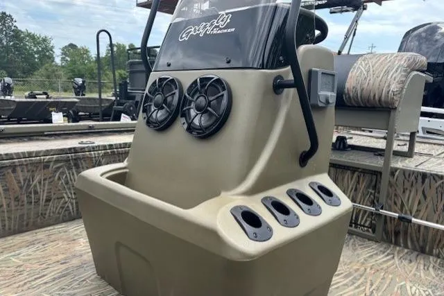 Slide: The Image of 2026 Tracker Grizzly 2072 CC Sportsman Kicker boat console with speakers and cup holders. - 18