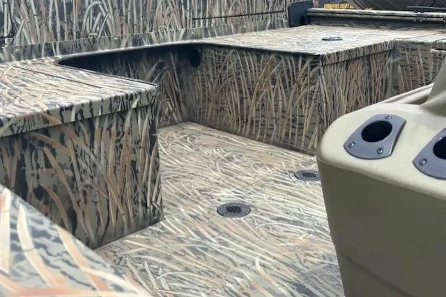 Slide: The Image of 2026 Tracker Grizzly 2072 CC Sportsman Kicker boat interior with camouflage design. - 21