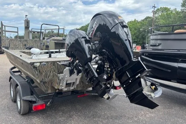 Slide: The Image of 2026 Tracker Grizzly 2072 CC Sportsman Kicker boat on trailer, featuring dual outboard motors. - 3