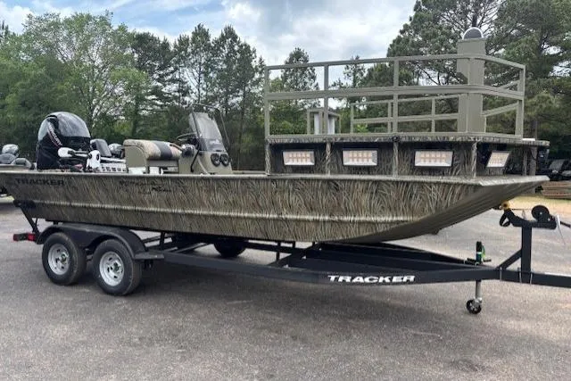 Slide: The Image of 2026 Tracker Grizzly 2072 CC Sportsman Kicker boat on trailer, outdoors, side view. - 4