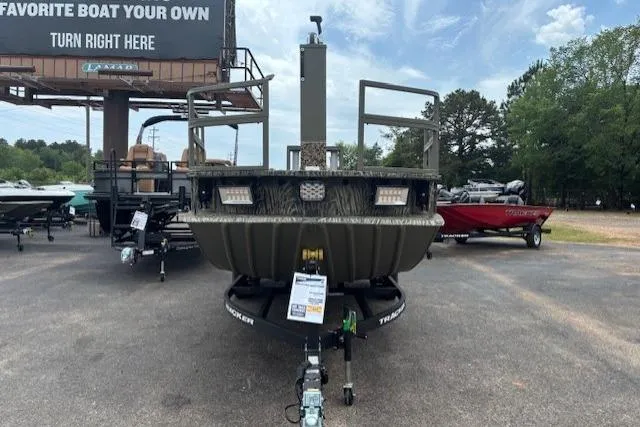 Slide: The Image of 2026 Tracker Grizzly 2072 CC Sportsman Kicker boat displayed outdoors on a trailer. - 5