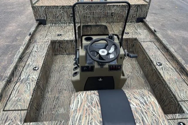 Slide: The Image of 2026 Tracker Grizzly 2072 CC Sportsman Kicker boat with camo interior and steering console. - 7