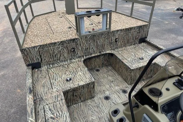 Slide: The Image of 2026 Tracker Grizzly 2072 CC Sportsman Kicker boat with camouflage interior design. - 8