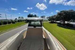 Slide: The Image of 2024 Chris-Craft Catalina 30 boat on a sunny day, showcasing sleek design and spacious deck. - 21