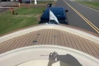 Slide: The Image of 2024 Chris-Craft Catalina 30 boat on trailer, wooden deck, parked on roadside. - 22