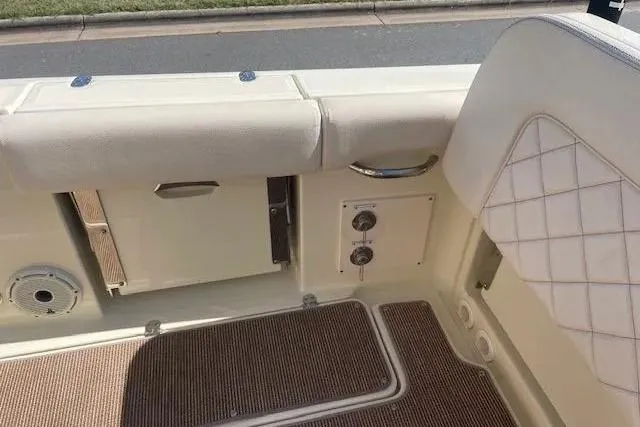 Slide: The Image of 2024 Chris-Craft Catalina 30 interior detail with beige upholstery and deck features. - 24