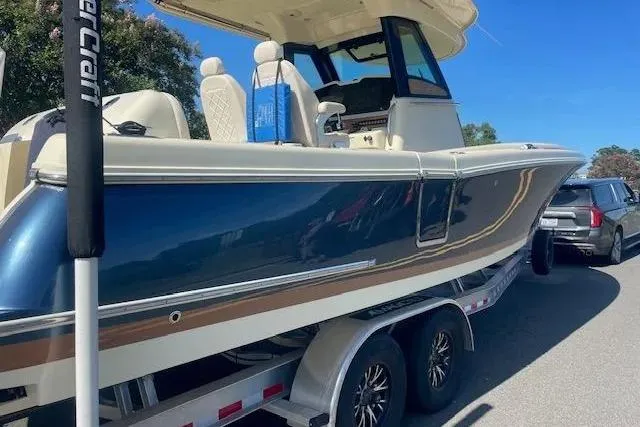 Slide: The Image of 2024 Chris-Craft Catalina 30 boat on trailer, featuring sleek design and luxurious seating. - 27
