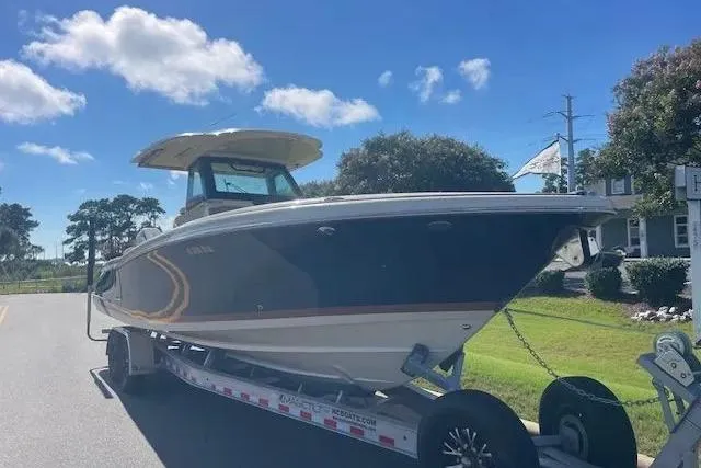 Slide: The Image of 2024 Chris-Craft Catalina 30 boat on trailer, parked on a sunny street. - 28