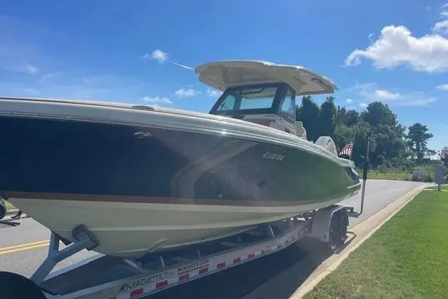 Slide: The Image of 2024 Chris-Craft Catalina 30 boat on trailer, parked on a sunny street. - 30