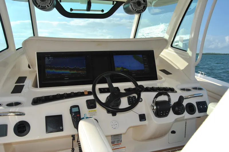 Slide: The Image of 2018 Grady-White Canyon 376 helm with advanced navigation displays and controls. - 10