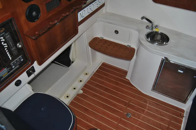 Slide: The Image of 2018 Grady-White Canyon 376 interior with wood flooring, sink, and seating area. - 14