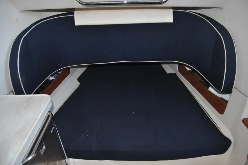 Slide: The Image of 2018 Grady-White Canyon 376 cabin interior with blue cushioned seating. - 15