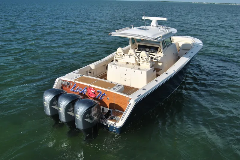 Slide: The Image of 2018 Grady-White Canyon 376 boat with triple Yamaha engines on open water. - 3