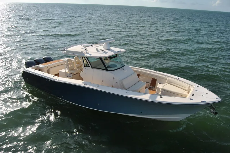 Slide: The Image of 2018 Grady-White Canyon 376 boat on open water, featuring sleek design and triple engines. - 4