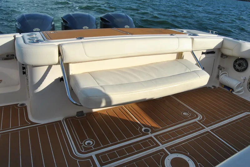 Slide: The Image of 2018 Grady-White Canyon 376 boat interior with cushioned seating and teak-style flooring. - 9