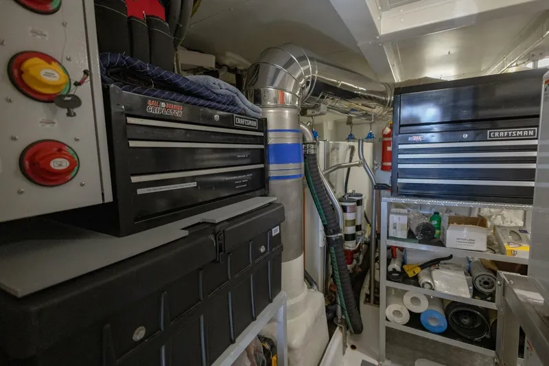 Slide: The Image of Engine room of 2021 Azimut Fly 72 yacht with toolboxes and equipment. - 68