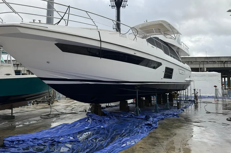 Slide: The Image of 2021 Azimut Fly 72 yacht on dry dock for maintenance under cloudy skies. - 82