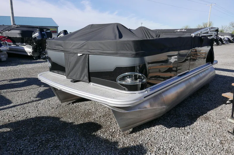 Slide: The Image of 2024 Avalon Venture Bow Fish 1575 pontoon boat with black cover on gravel lot. - 12