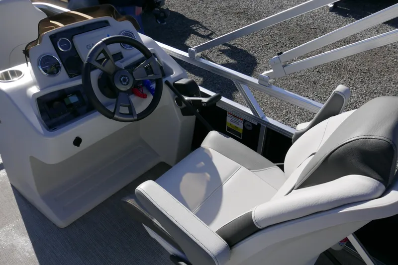Slide: The Image of 2024 Avalon Venture Bow Fish 1575 boat cockpit with steering wheel and comfortable seating. - 7