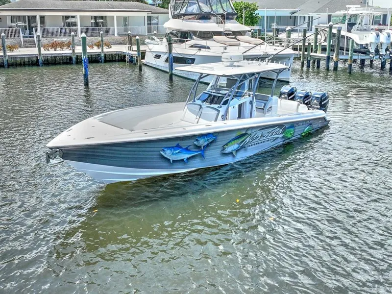 Slide: The Image of 2020 Nor-Tech 340 Sport boat docked in marina, featuring vibrant marine graphics. - 18