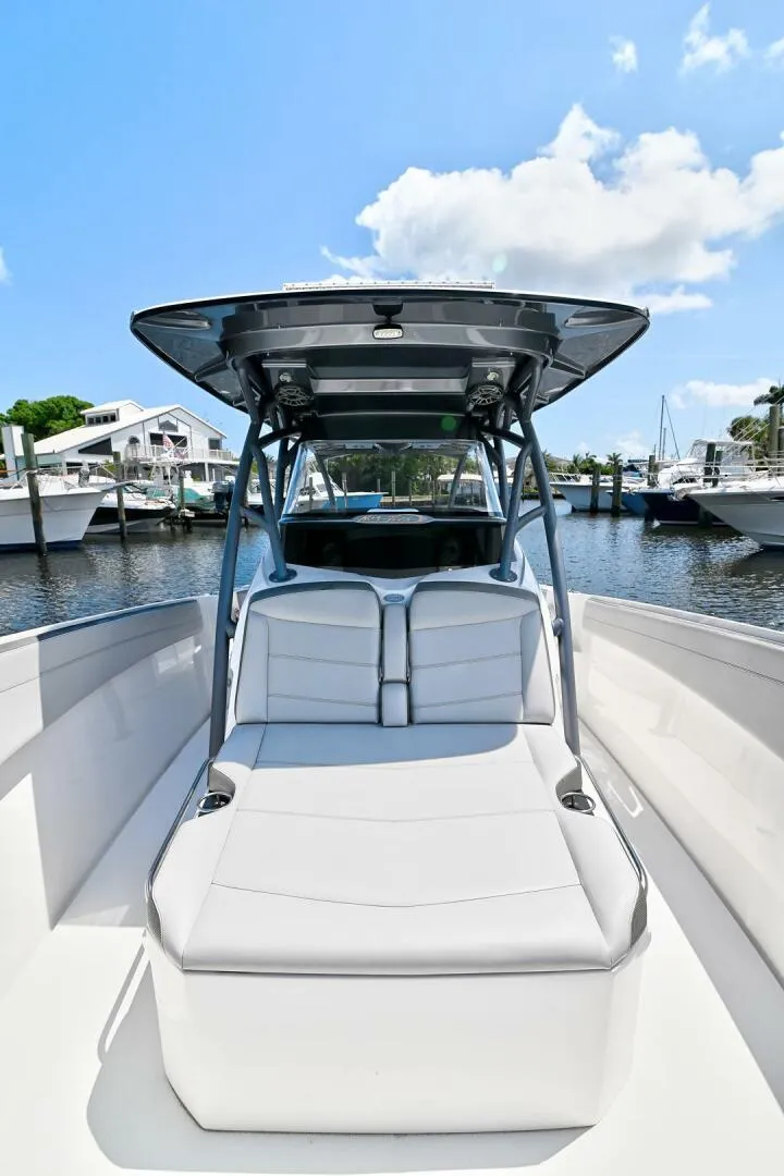 Slide: The Image of 2020 Nor-Tech 340 Sport boat docked at marina under clear blue sky. - 26