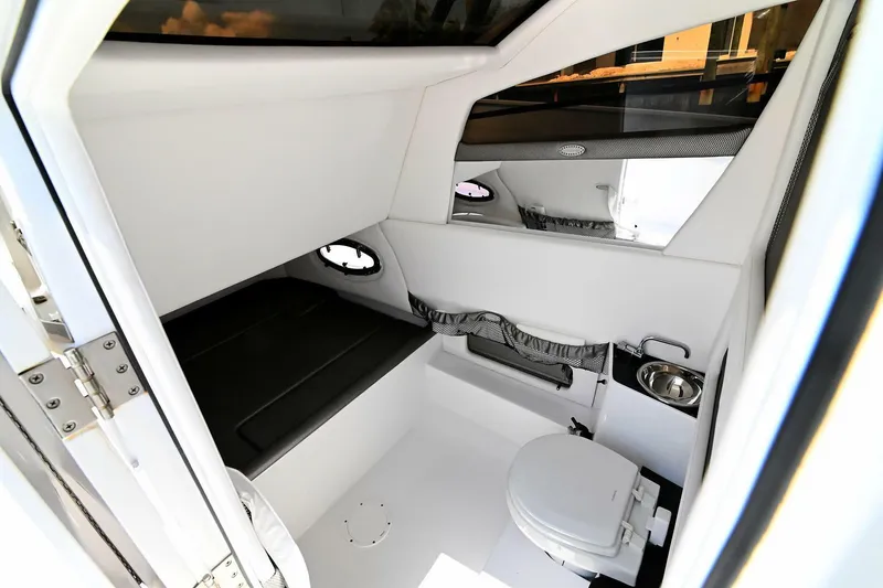 Slide: The Image of 2020 Nor-Tech 340 Sport cabin interior with seating and toilet, featuring modern design and amenities. - 29