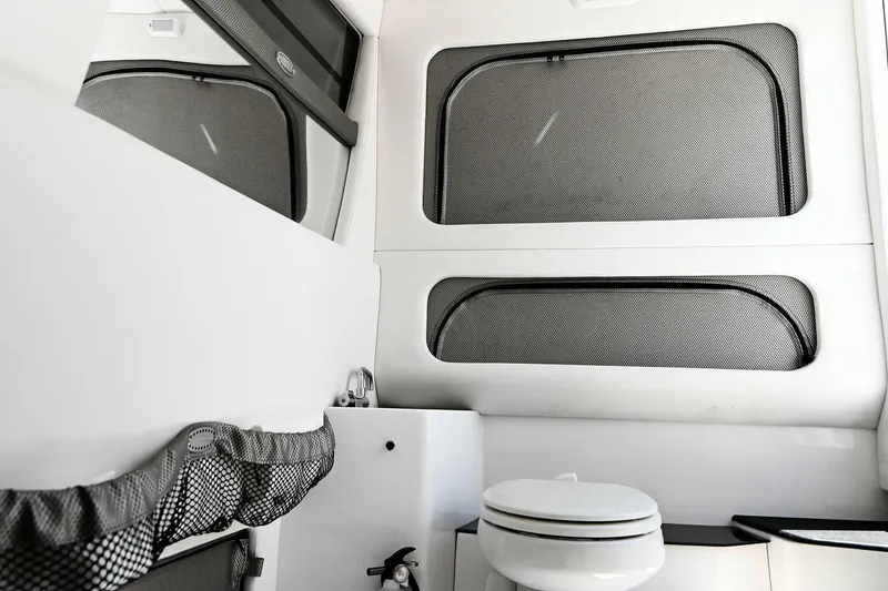 Slide: The Image of 2020 Nor-Tech 340 Sport boat interior with modern bathroom amenities. - 30