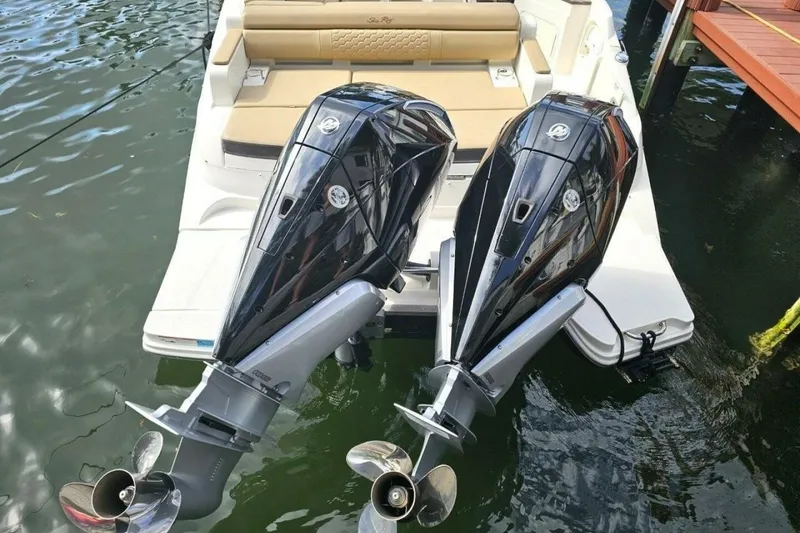 Slide: The Image of 2018 Sea Ray SDX 290 Outboard with dual engines, docked on calm water. - 10