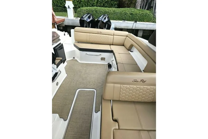 Slide: The Image of 2018 Sea Ray SDX 290 Outboard interior with tan seating and dual outboard engines. - 13