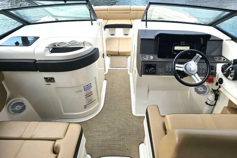 Slide: The Image of 2018 Sea Ray SDX 290 Outboard boat interior with beige seating and modern dashboard. - 14