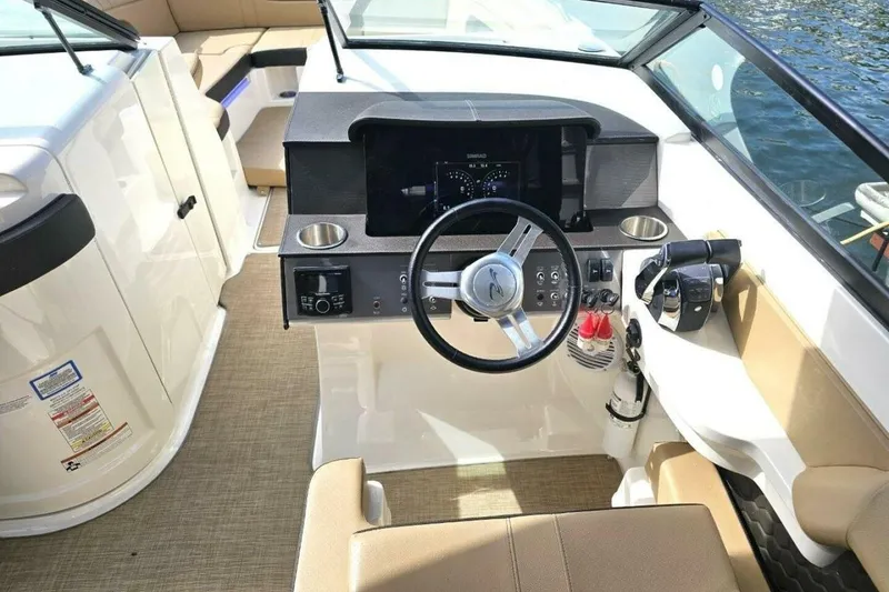 Slide: The Image of 2018 Sea Ray SDX 290 Outboard boat cockpit with steering wheel and control panel. - 21