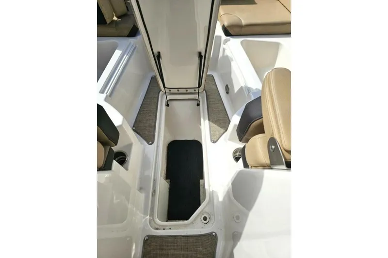 Slide: The Image of 2018 Sea Ray SDX 290 Outboard interior storage compartment with beige seating. - 25