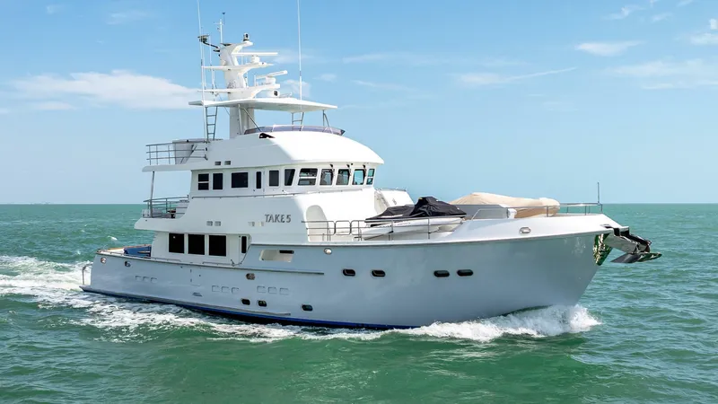 The Image of Nordhavn 76 yacht cruising on open sea, 2009 model, under clear blue sky. - 1