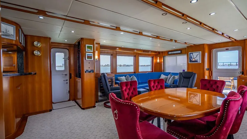 Slide: The Image of Luxurious interior of 2009 Nordhavn 76 yacht with elegant dining area and plush seating. - 11