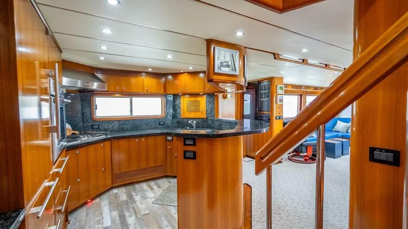 Slide: The Image of Luxurious 2009 Nordhavn 76 yacht interior with modern kitchen and elegant wood finishes. - 14