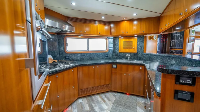 Slide: The Image of Luxurious kitchen interior of 2009 Nordhavn 76 yacht with wood cabinetry and modern appliances. - 15