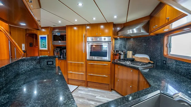 Slide: The Image of Luxurious kitchen interior of 2009 Nordhavn 76 yacht with wood cabinetry and granite countertops. - 17