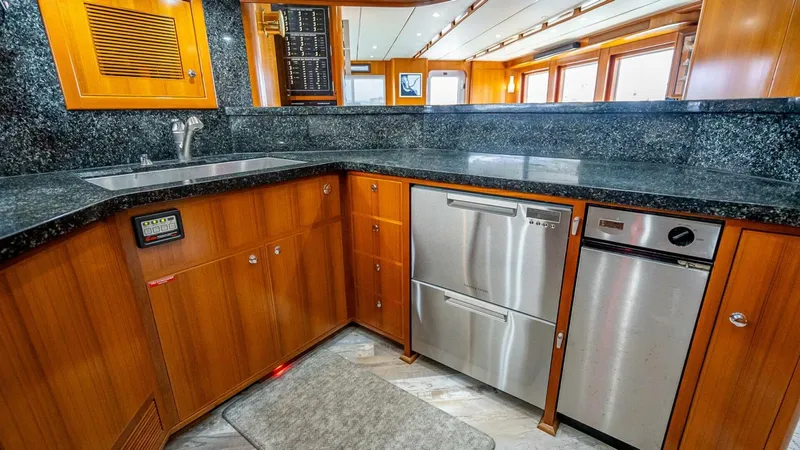 Slide: The Image of Luxurious kitchen in 2009 Nordhavn 76 yacht with wood cabinetry and stainless steel appliances. - 18