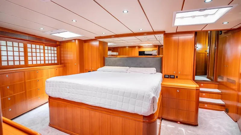 Slide: The Image of Luxurious wooden interior of 2009 Nordhavn 76 yacht bedroom with large bed. - 19