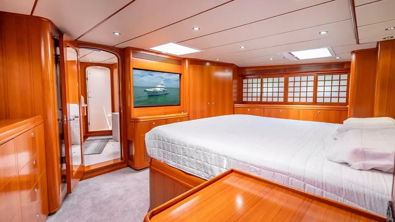 Slide: The Image of Luxurious cabin interior of 2009 Nordhavn 76 yacht with wood paneling and large bed. - 20