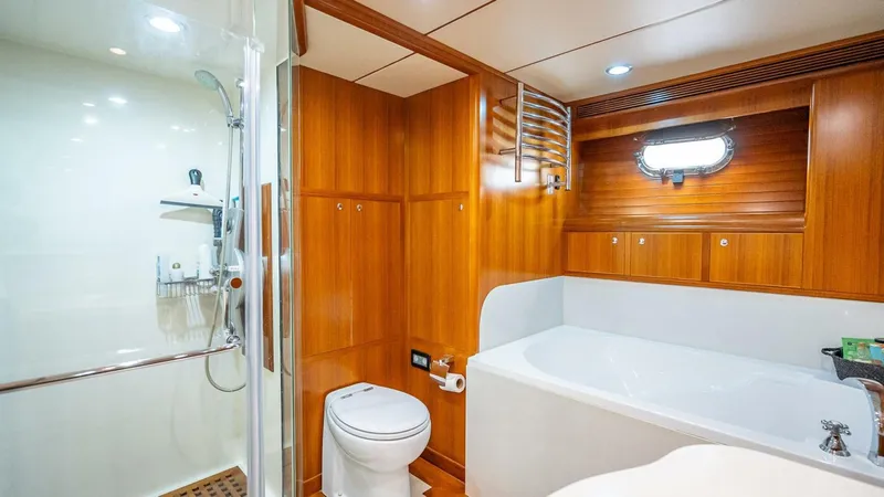 Slide: The Image of Luxurious bathroom in 2009 Nordhavn 76 yacht with wood paneling, shower, and bathtub. - 21