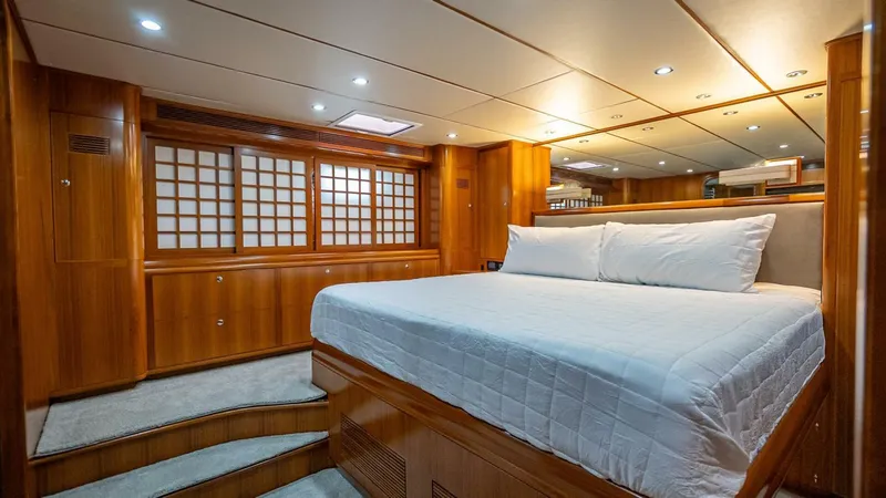Slide: The Image of Luxurious cabin interior of 2009 Nordhavn 76 yacht with wooden finishes and cozy bed. - 29