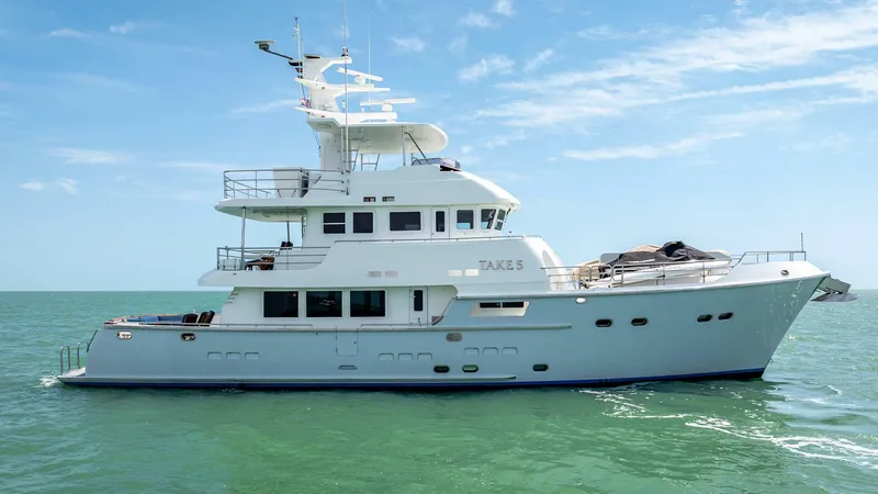 Slide: The Image of 2009 Nordhavn 76 yacht cruising on calm sea under clear blue sky. - 3