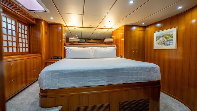 Slide: The Image of Luxurious cabin interior of 2009 Nordhavn 76 yacht with wood paneling and cozy bed. - 31