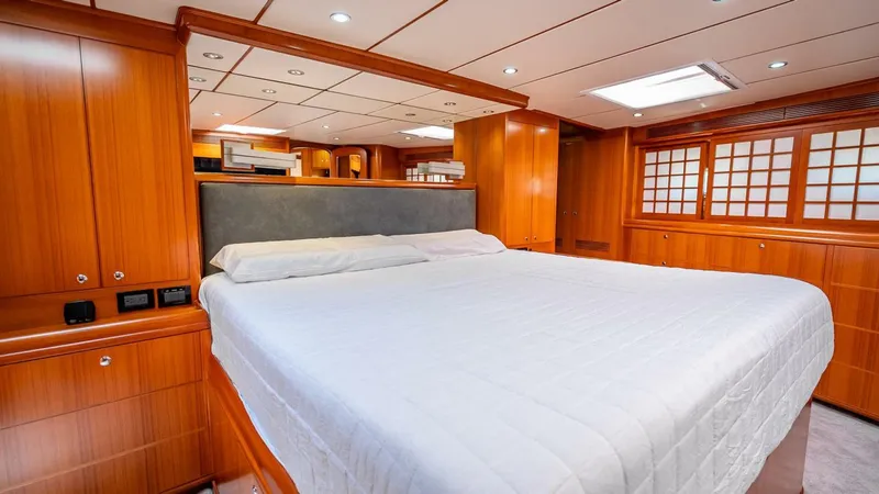 Slide: The Image of Luxurious cabin interior of 2009 Nordhavn 76 yacht with wood paneling and spacious bed. - 32